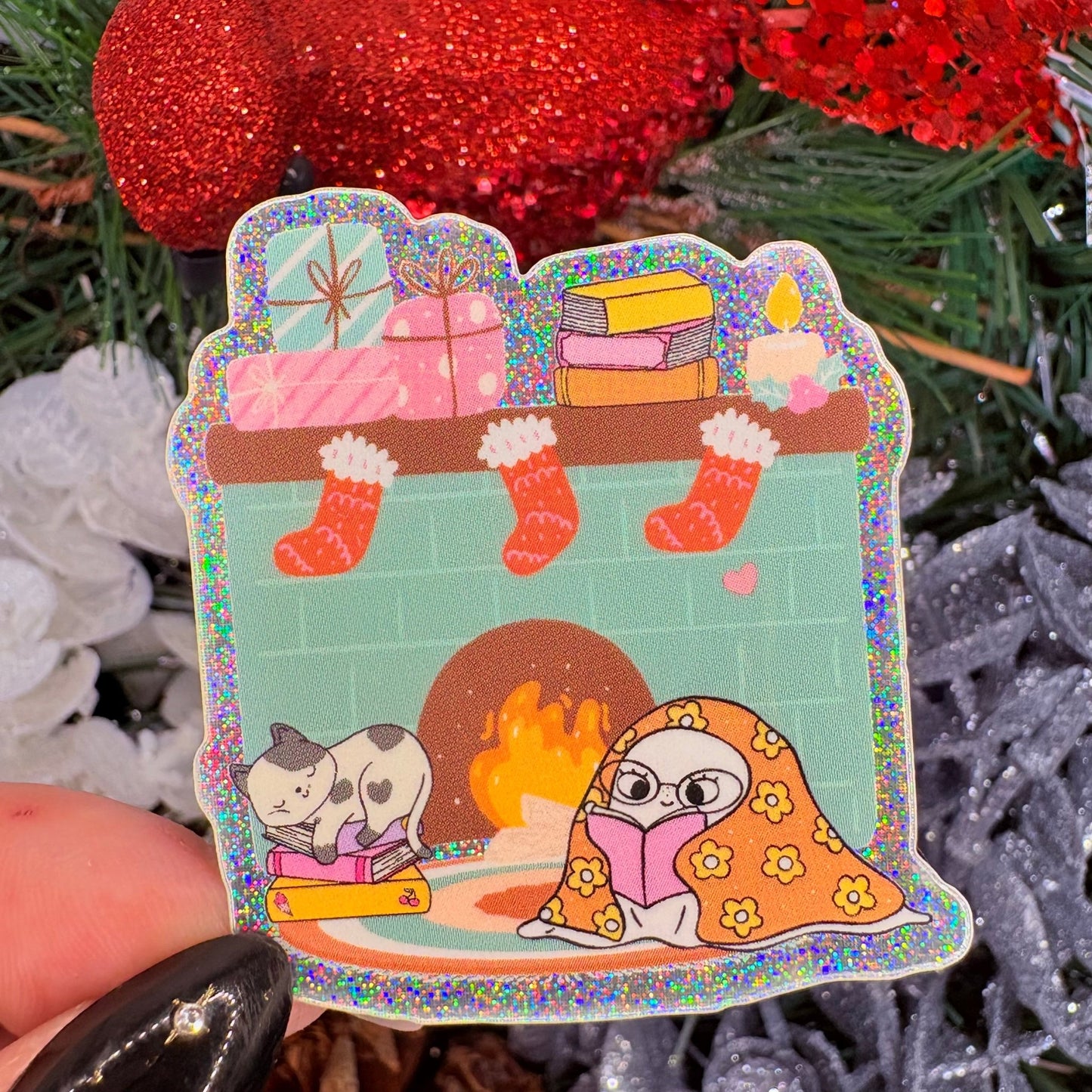 Cozy Ghost Reading at the Fireplace Holiday Sticker - Crushed Glitter Finish - Awfullynerdy.co