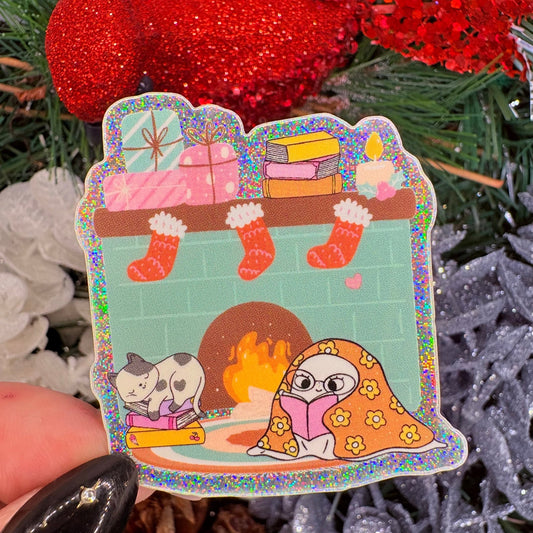 Cozy Ghost Reading at the Fireplace Holiday Sticker - Crushed Glitter Finish - Awfullynerdy.co